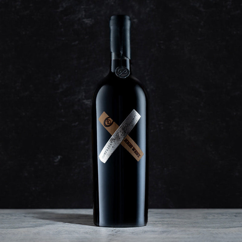 Bottle of complicit red wine collaboration with High West on a dark gray background