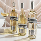 Three bottles of Blindfold wines with a glass on a light background