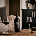 A bottle of Double Diamond : 2021 Napa Valley Proprietary Red Wine 750mL on a table with wine glasses nearby. 