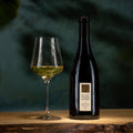 Bottle and glass of wine with Mount Veeder Winery label on a dark background