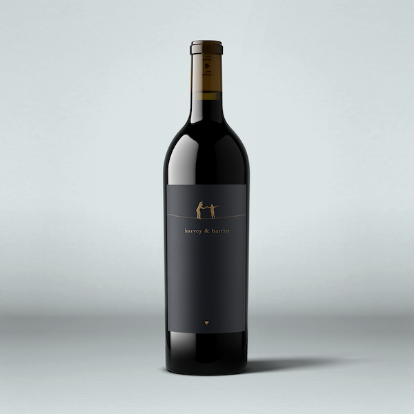 A bottle of 2021 Harvey & Harriet Red Blend wine with a dark label and a simple, elegant design.