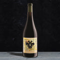 Wine bottle with decorative label on a dark background