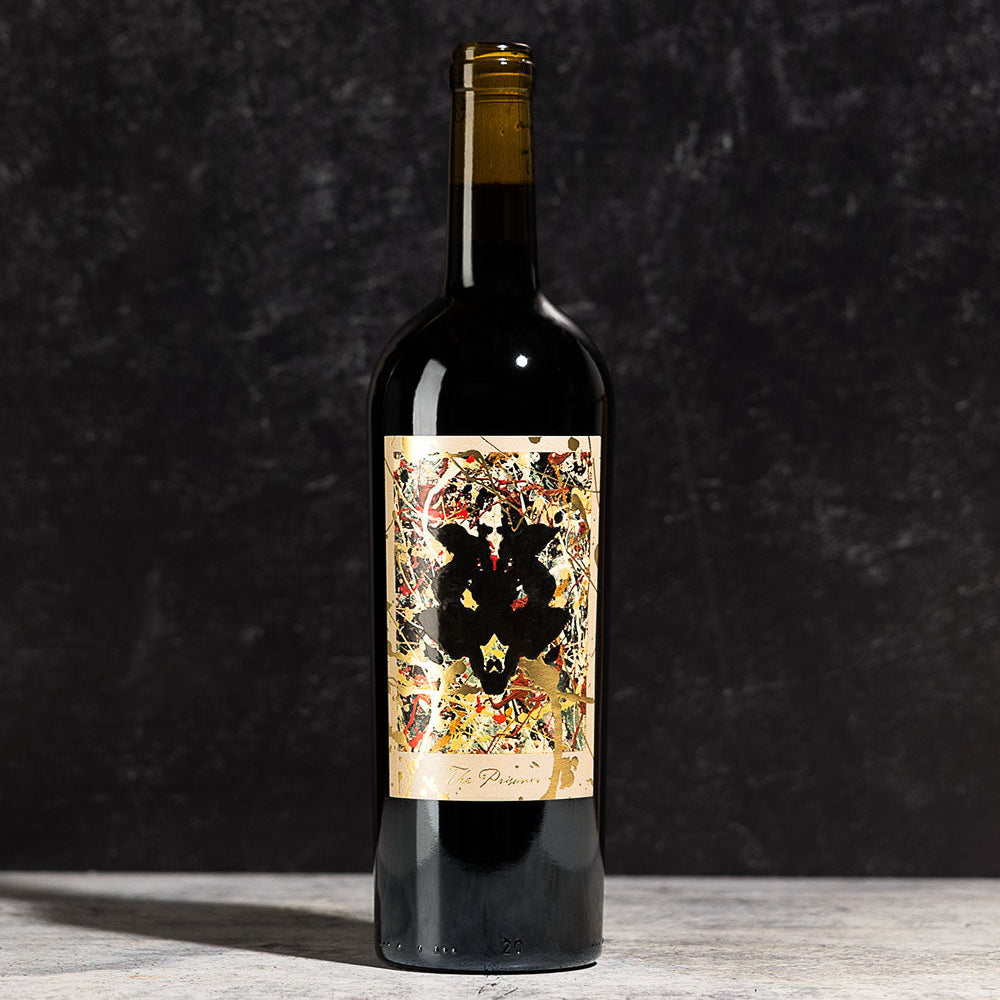 A bottle of The Prisoner Winemaker's Series with a decorative label on a dark background