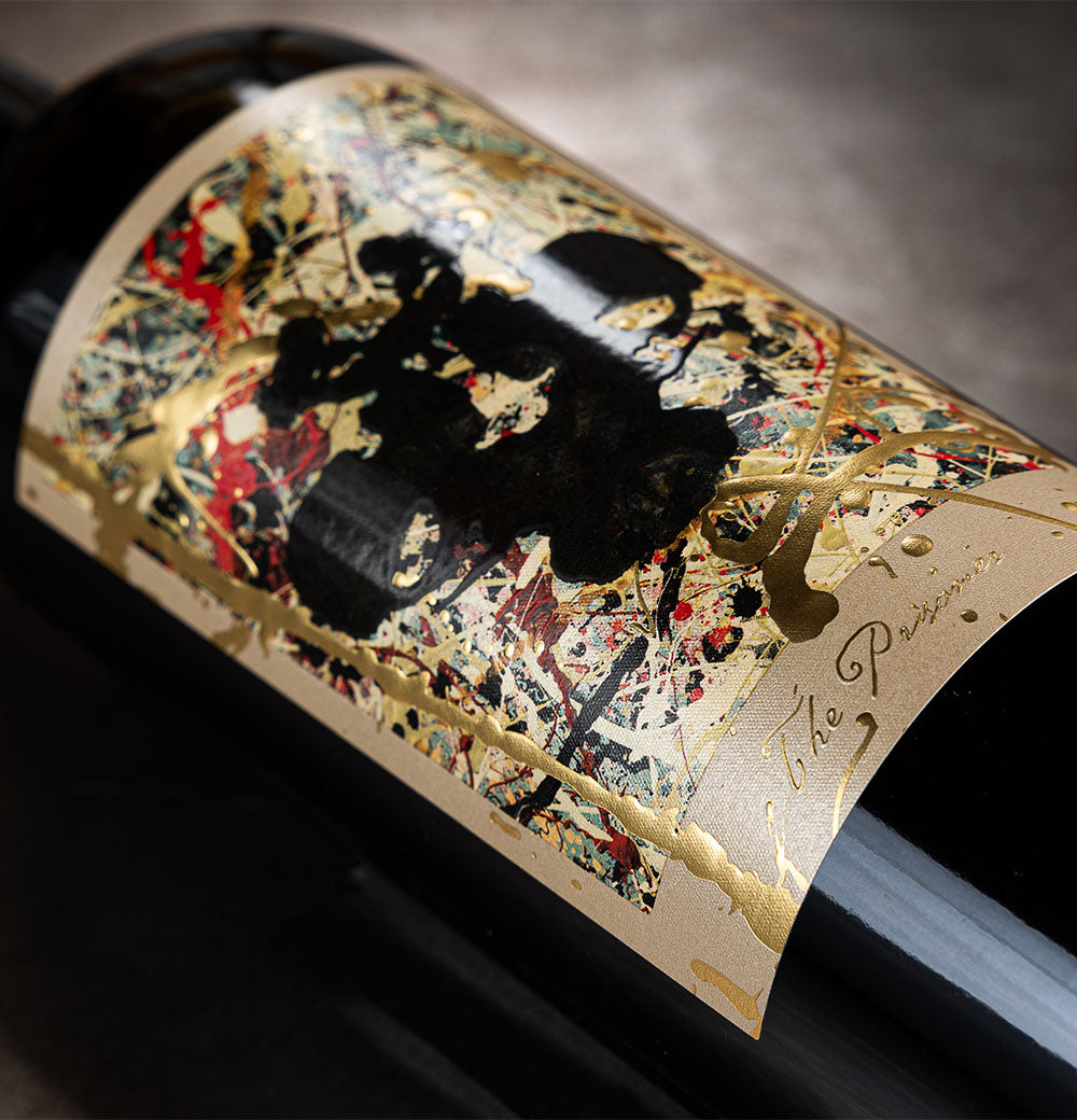 Close-up of a wine bottle label with artistic design and text.