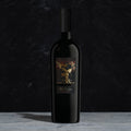 A bottle of The Prisoner Reserve Red Blend on a dark background