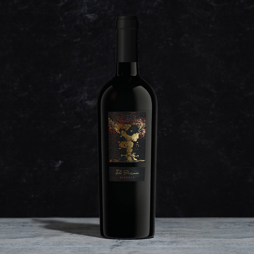 A bottle of The Prisoner Reserve Red Blend on a dark background