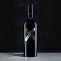 Bottle of complicit red wine collaboration with High West on a dark gray background