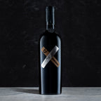 Bottle of complicit red wine collaboration with High West on a dark gray background