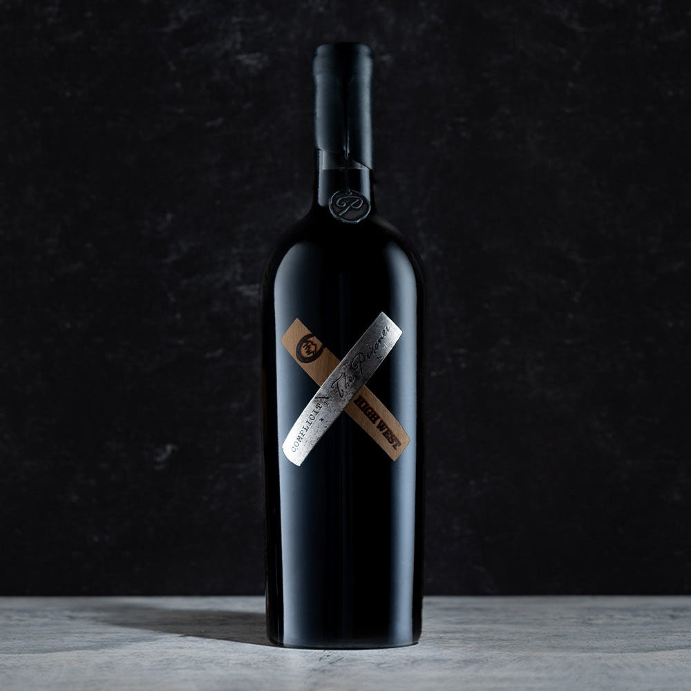 Bottle of complicit red wine collaboration with High West on a dark gray background