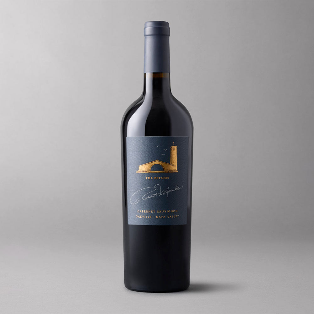 A bottle of Robert Mondavi Winery The Estates Cabernet Sauvignon Oakville on a gray background