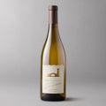 A bottle of Robert Mondavi Winery Chardonnay , featuring a cream-colored label with a brown illustration of an arch and a tower, set against a solid gray background.