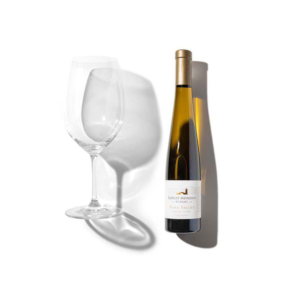 A bottle of 2020 Robert Mondavi Winery Moscato d'Oro Napa Valley white wine next to a filled wine glass.