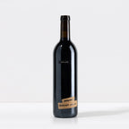 Wine bottle with a black label 'SALDO' and 'Carignan Alexander Valley' on tape at the bottom of the bottle on a white background