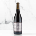 Unshackled Pinot Noir bottle on a white background