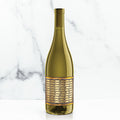 Unshackled wine bottle with a gold label on a marble background
