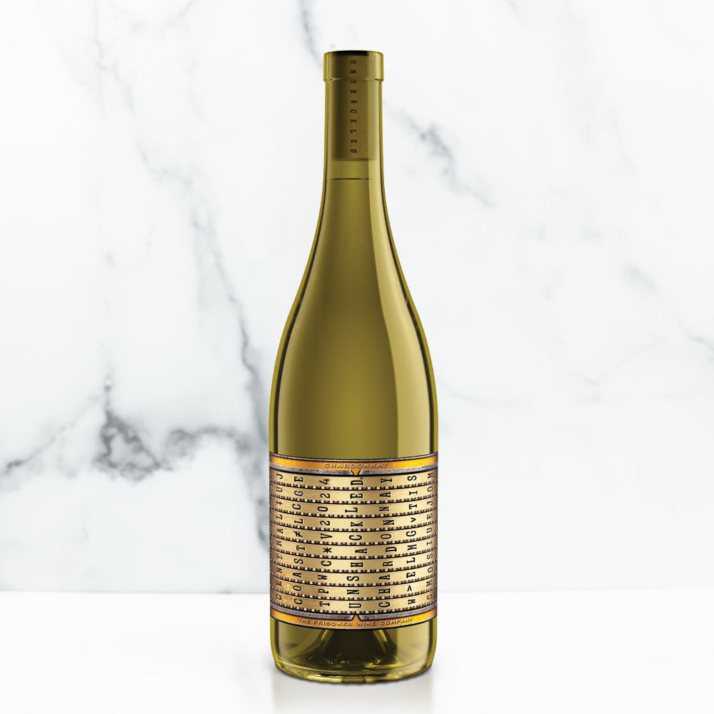 Unshackled wine bottle with a gold label on a marble background
