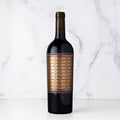A bottle of Unshackled Red Blend on a white marbled background.