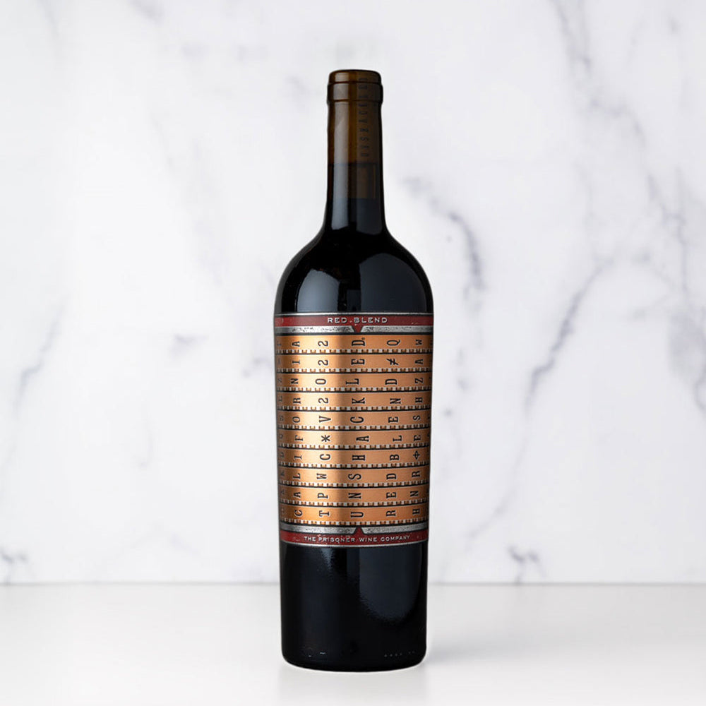 A bottle of Unshackled Red Blend on a white marbled background.