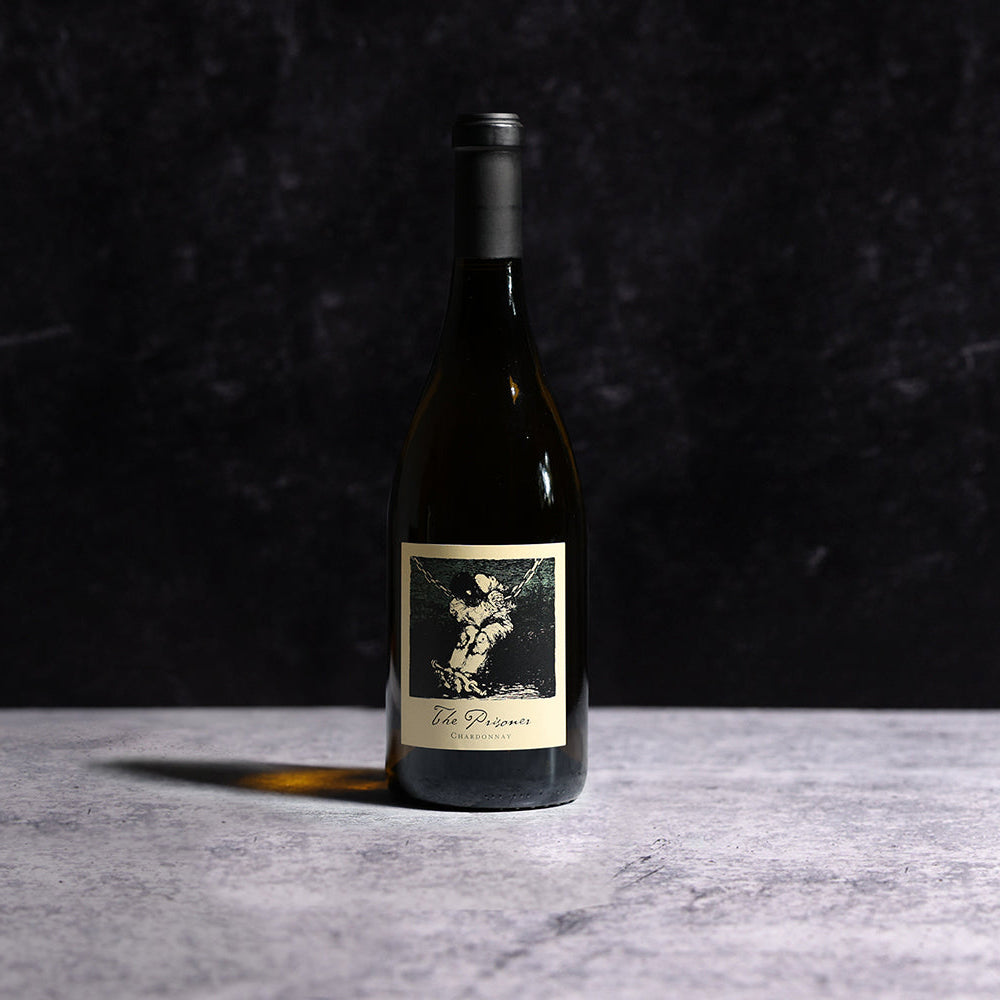 A Bottle Of  2022 The Prisoner Chardonnay Carneros Wine On A Gray Background